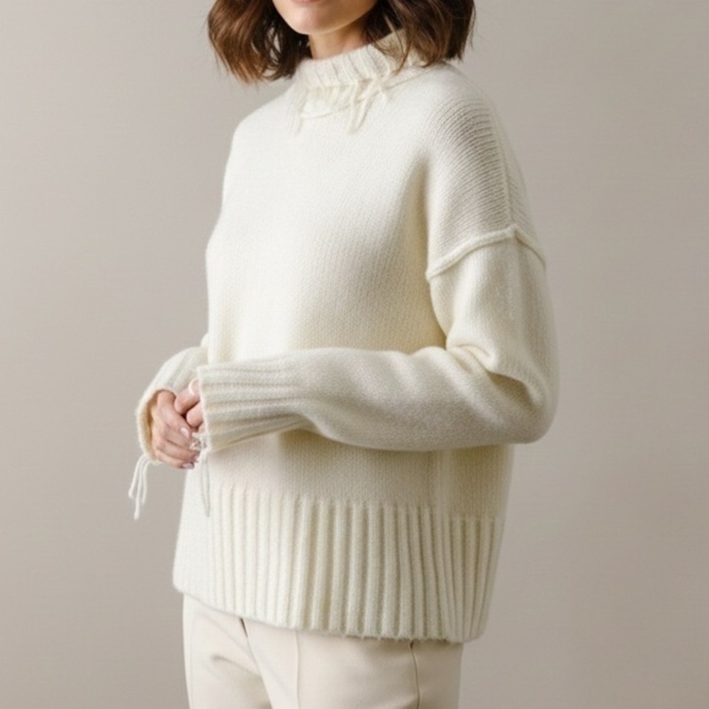 NSF Kori Distressed Fringe Wool Blend Turtleneck Sweater in Ivory Cream